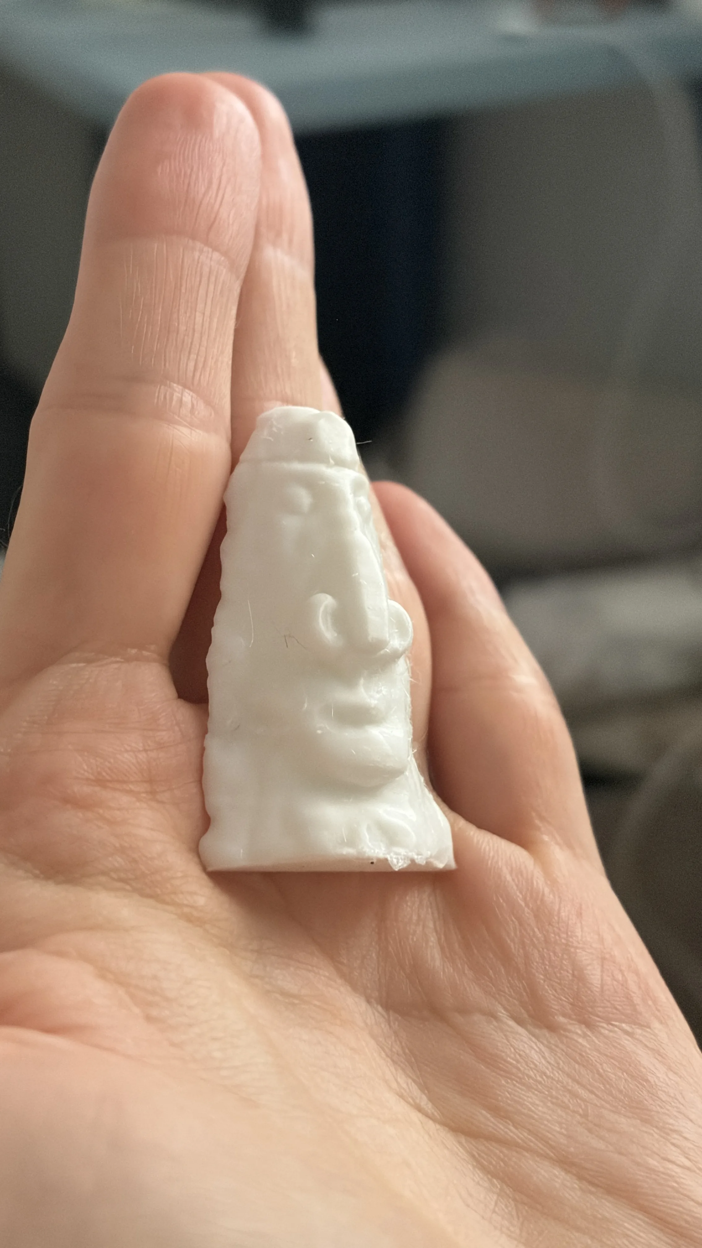 The printed desert statue held in a hand, three quarter view